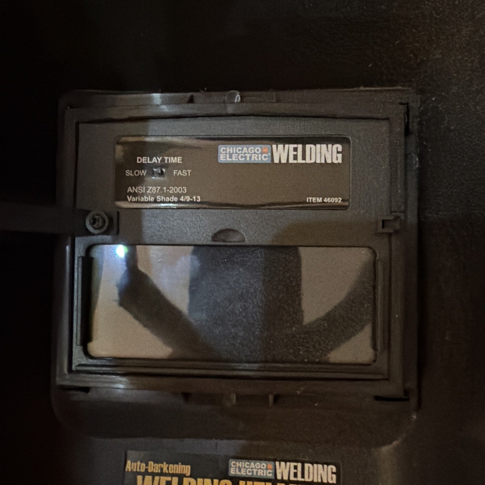 Chicago Electric auto-darkening welding helmet close-up showing adjustable delay time and variable shade settings