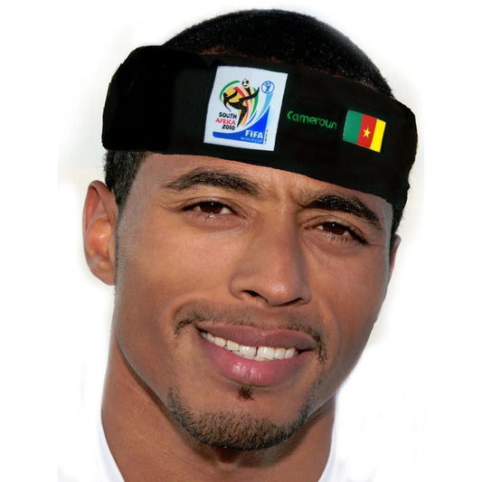 Man with a trimmed beard wearing a black headband featuring the 2010 FIFA World Cup South Africa logo, the name "Cameroon," and the Cameroonian flag on a white background.