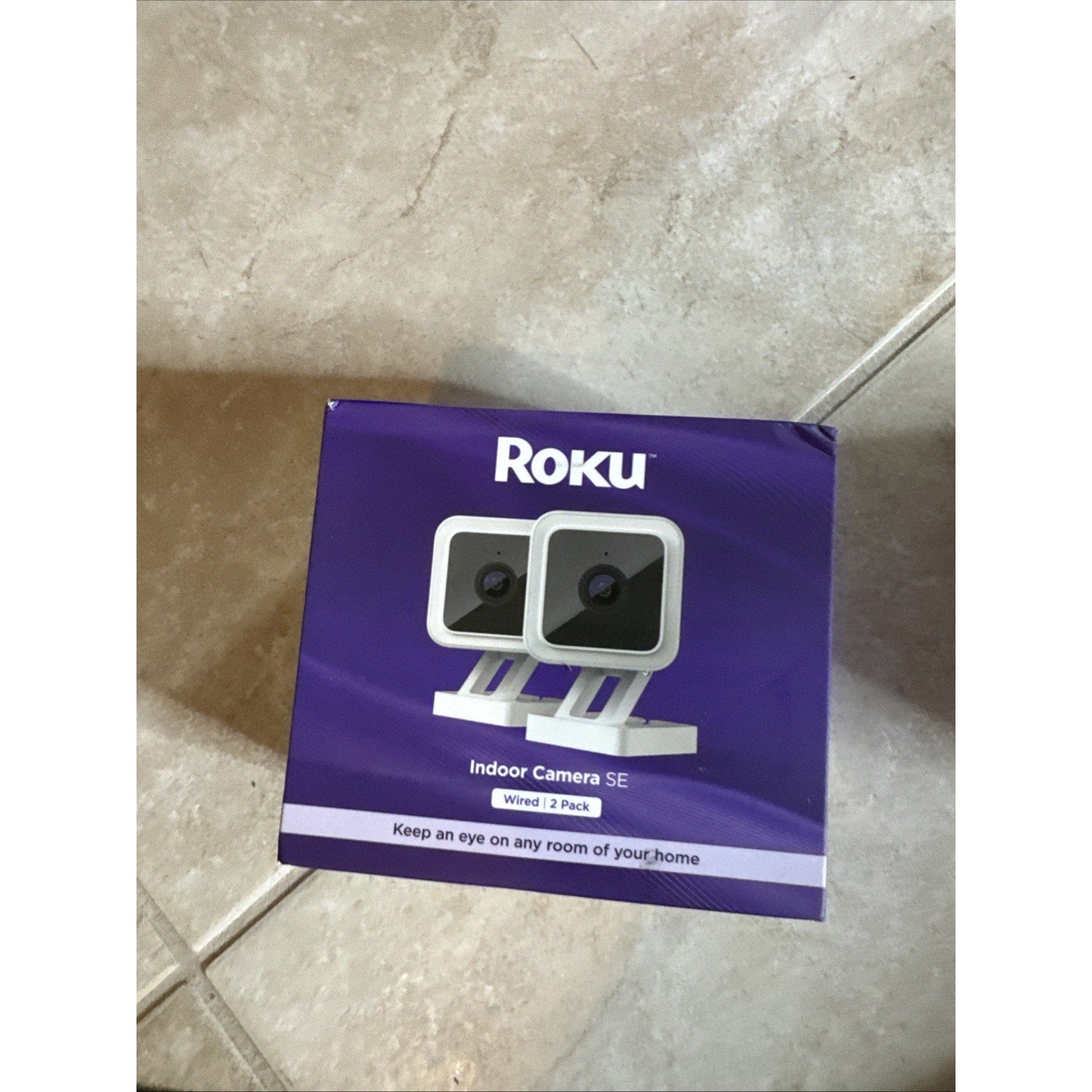 Roku Indoor Camera SE wired 2 pack box showing two white indoor security cameras on purple background