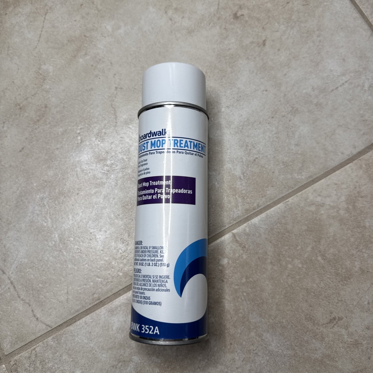 Boardwalk 352AEA 18 oz. spray dust mop treatment can with white cap on tiled floor surface