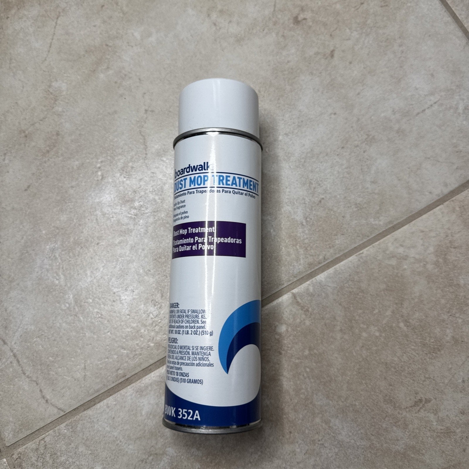 Boardwalk 352AEA 18 oz. spray dust mop treatment can with white cap on tiled floor surface
