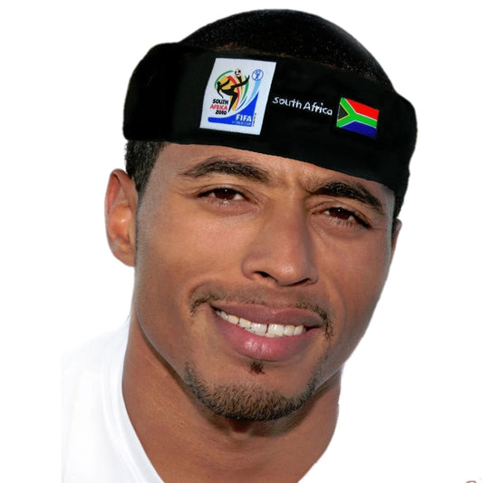 Man smiling and wearing a black headband with the 2010 FIFA World Cup South Africa logo, the South African flag, and "South Africa" text on a white background.