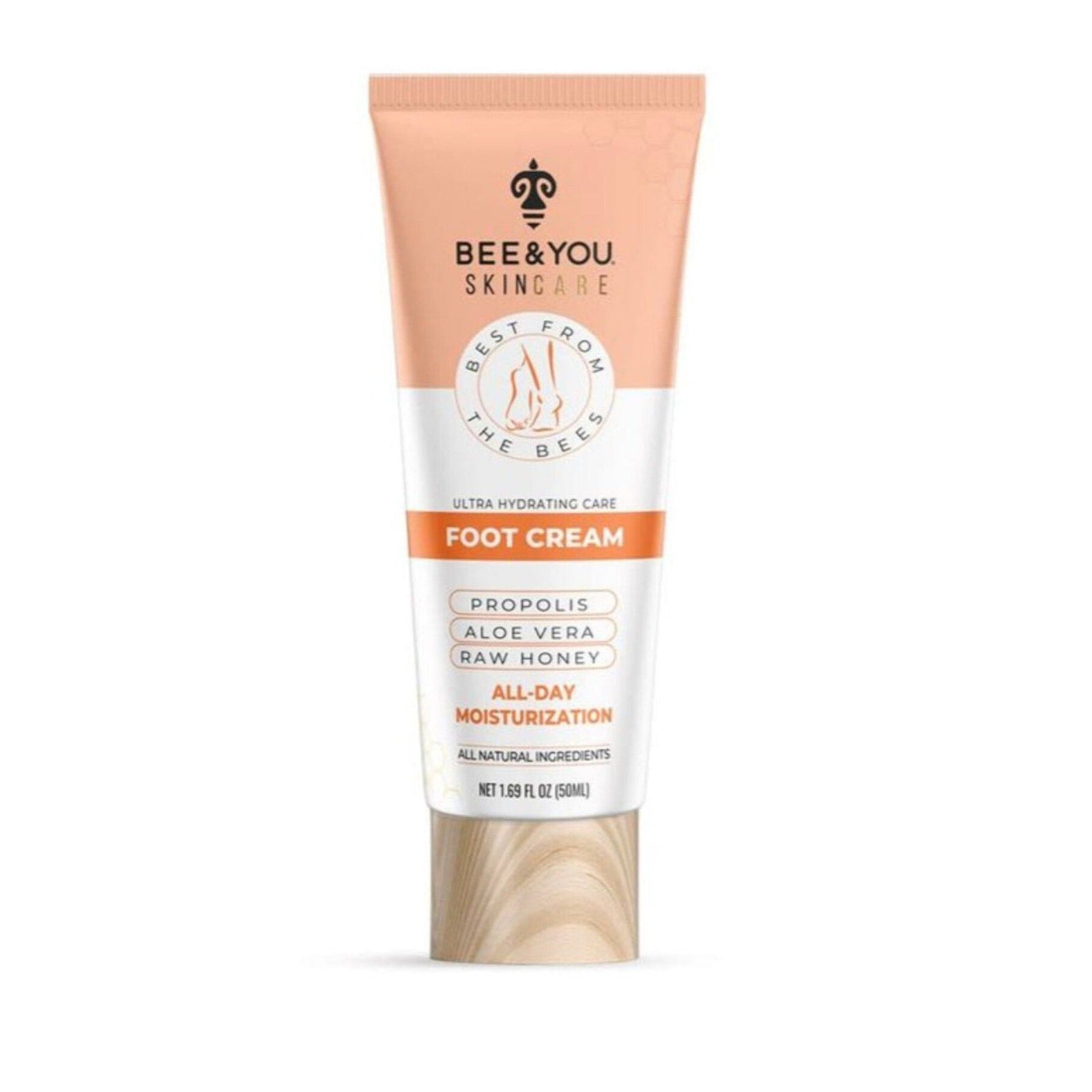 Tube of Bee & You Skincare foot cream with peach and white label, featuring propolis, aloe vera, raw honey, and all-day moisturizing, with a wood-textured cap on a white background.
