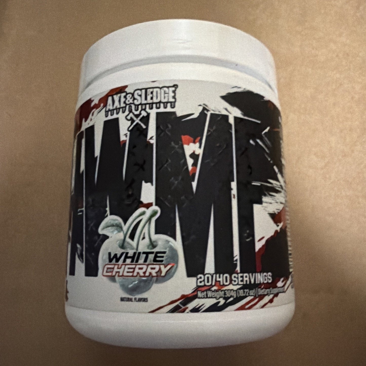 White plastic container of Axe & Sledge Nightmare dietary supplement in white cherry flavor, featuring bold black and red graphic text on the label.