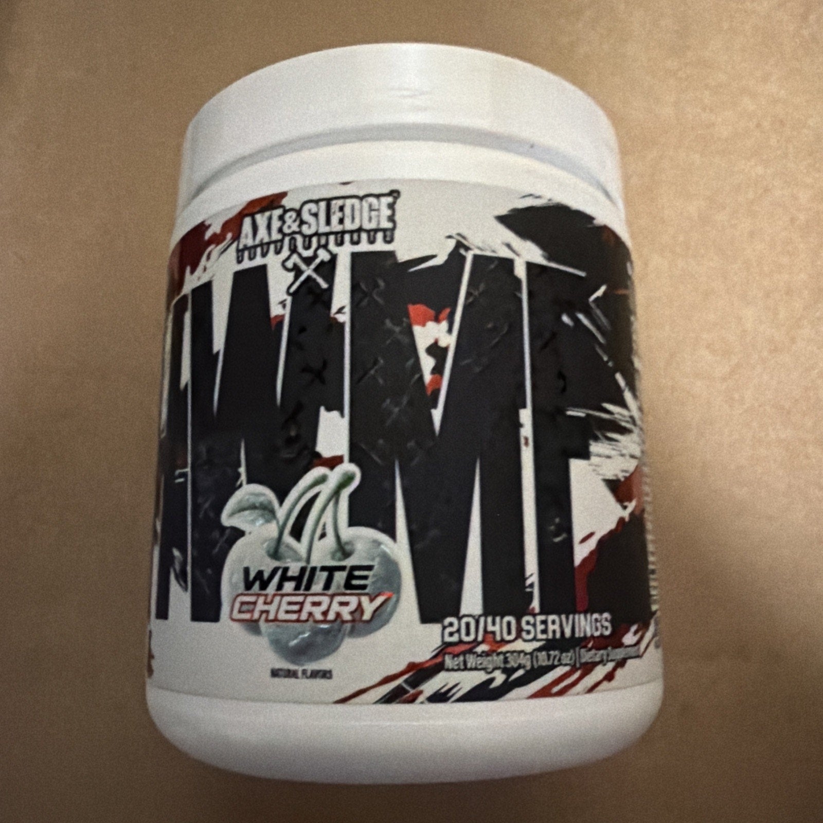 White plastic container of Axe & Sledge Nightmare dietary supplement in white cherry flavor, featuring bold black and red graphic text on the label.