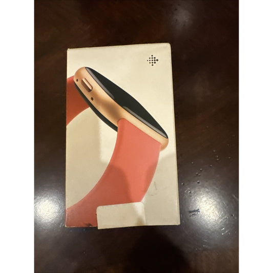 Fitbit Versa 4 smartwatch box showing pink sand band and copper rose aluminum case on white background