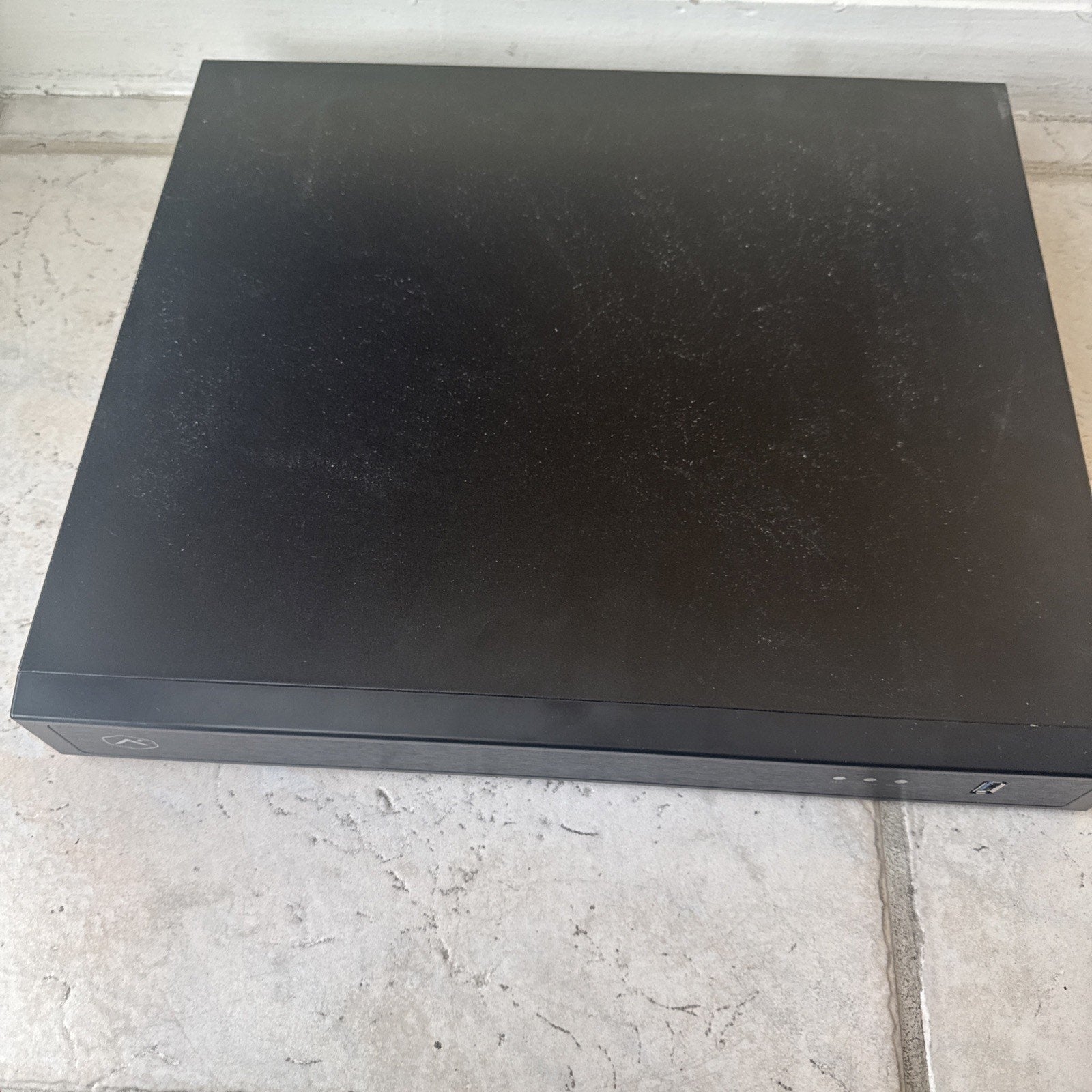 Alarm.com 8 channel commercial streaming video recorder with 3TB storage in black rectangular case on floor