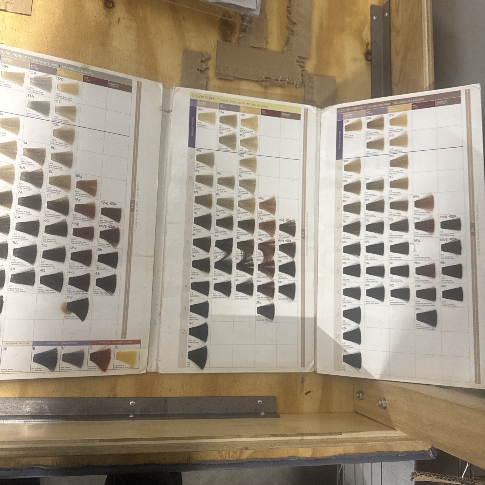 Wella Color Perfect Color Guide showing a range of hair color swatches organized by shade and tone on fold-out panels