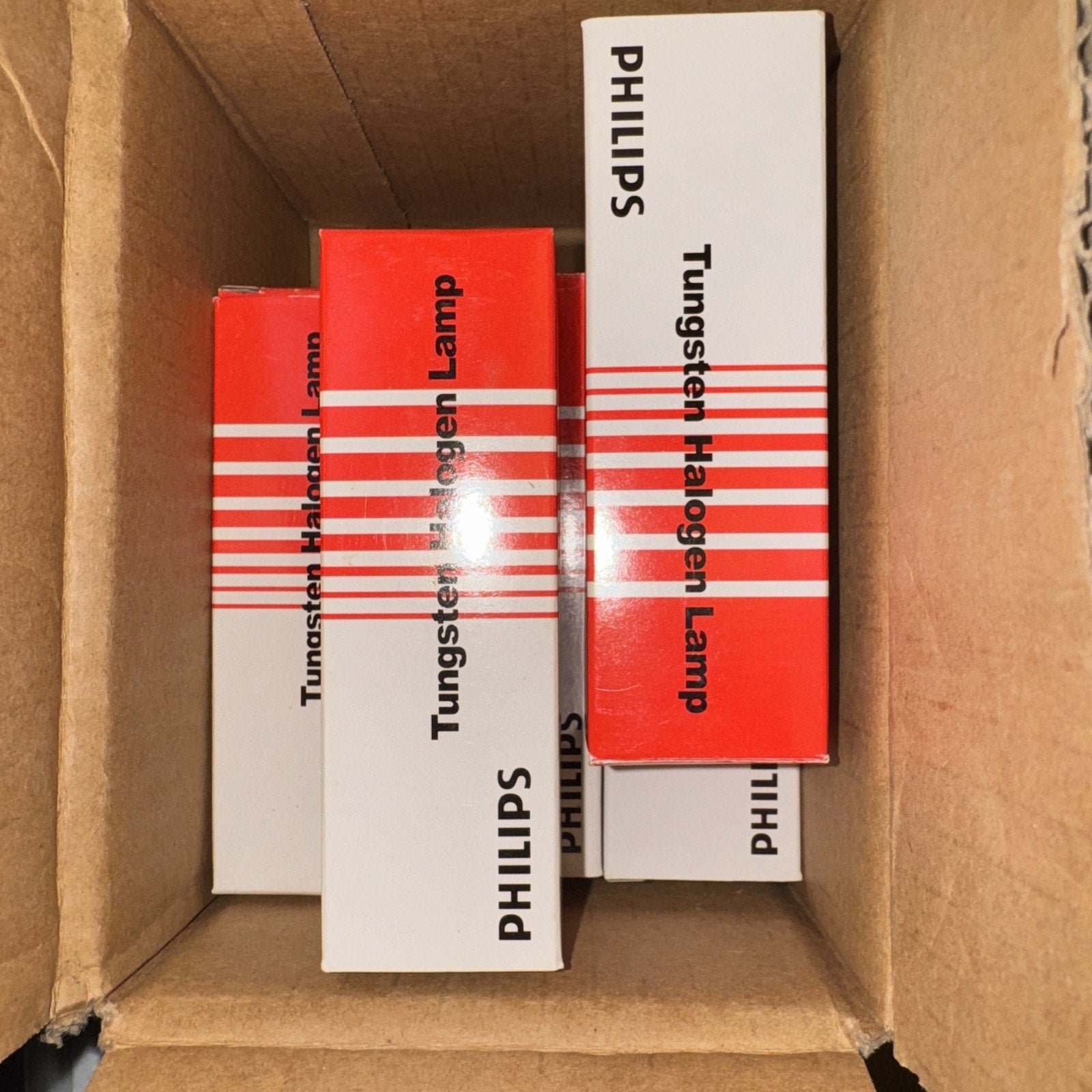 Lot of 8 new Philips 150Q/DC (120V) tungsten halogen lamps in original white and red packaging inside a cardboard box