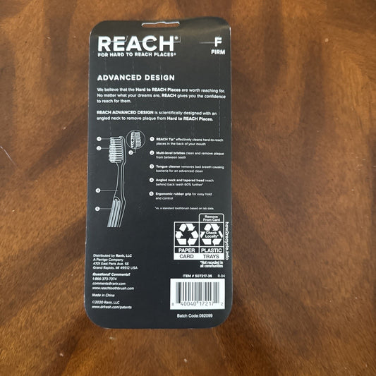REACH Advanced Design adult firm toothbrush packaging showing product features and barcode on black background