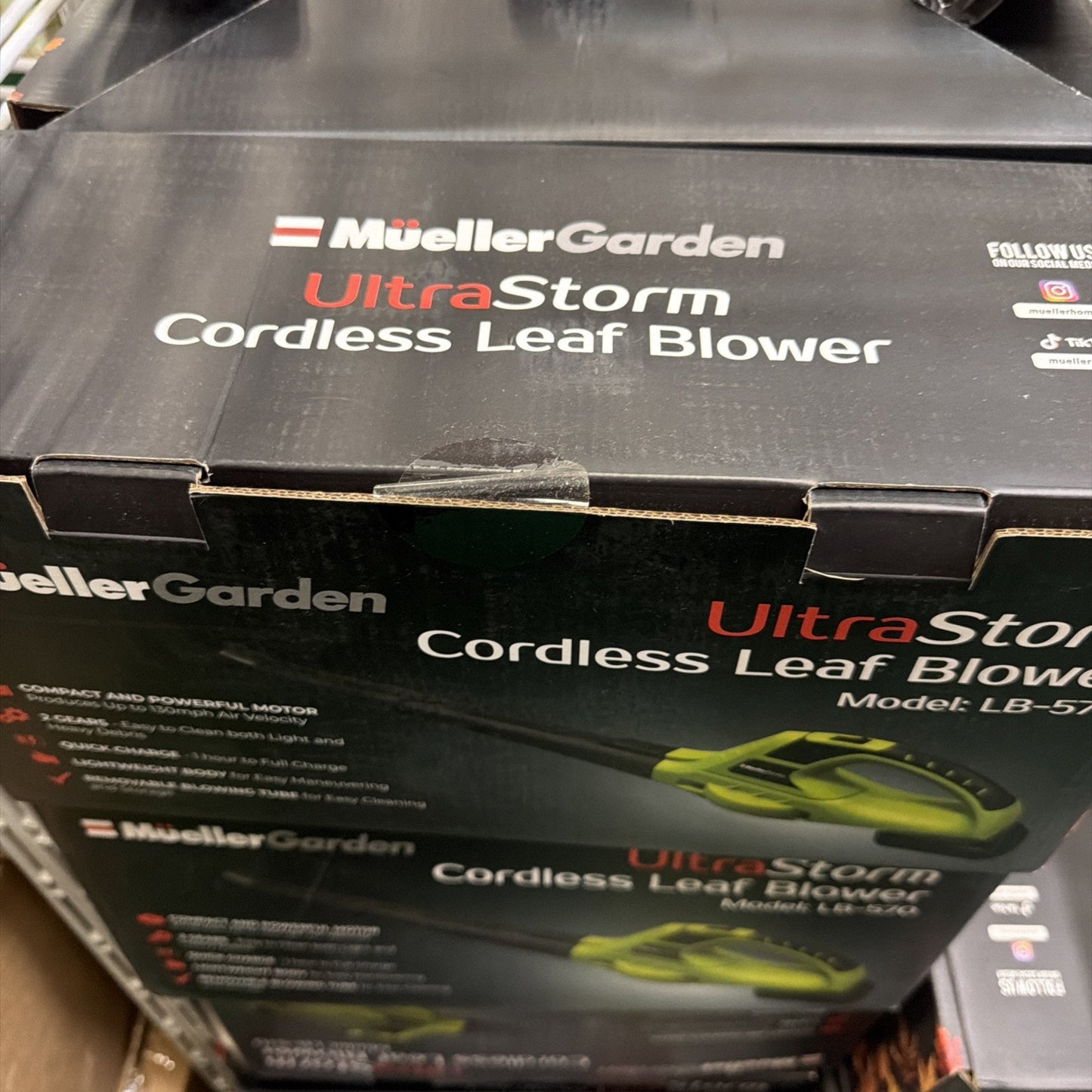 Packaging box for a MuellerGarden UltraStorm cordless leaf blower showing product name and a partial image of the green and black blower on a dark background.