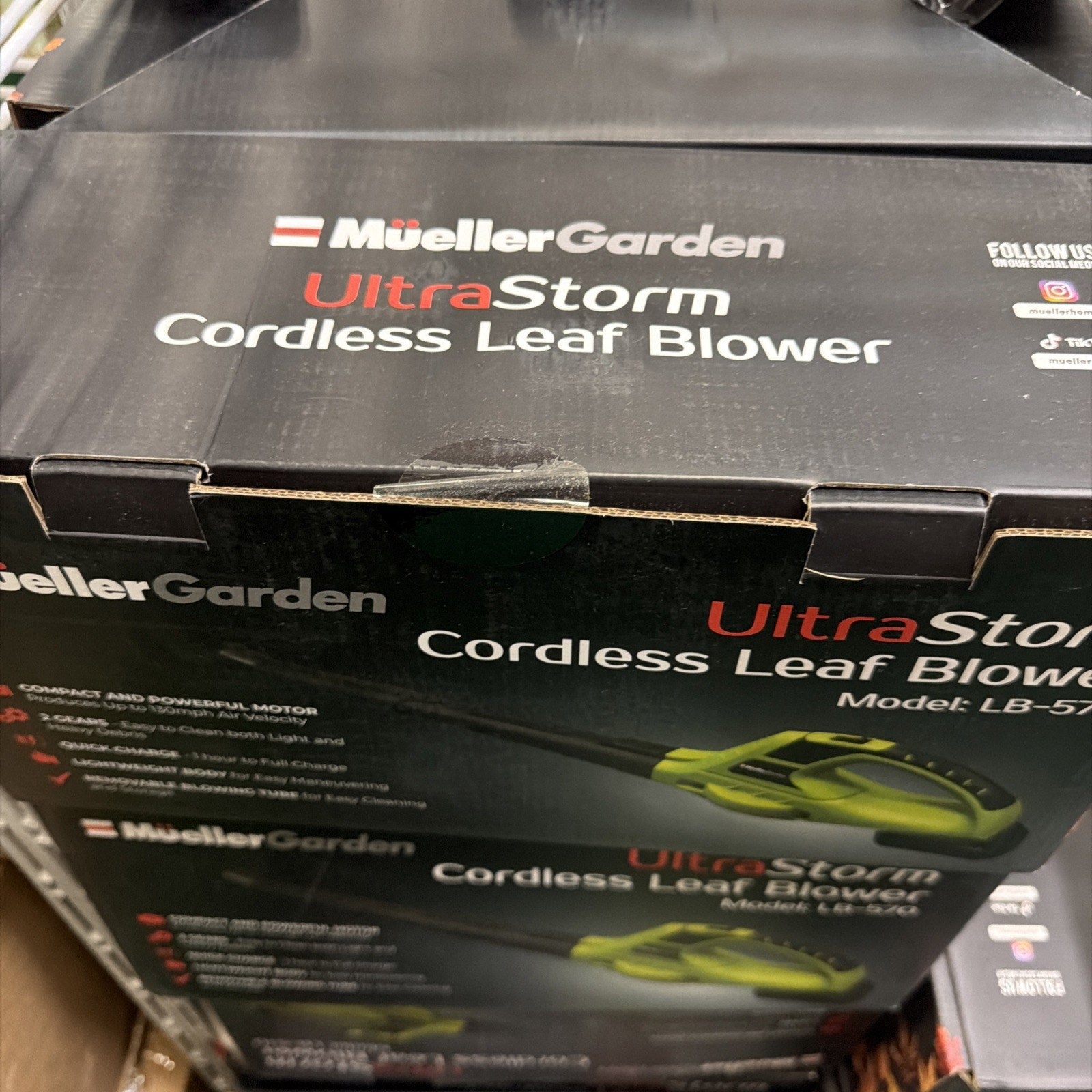 Packaging box for a MuellerGarden UltraStorm cordless leaf blower showing product name and a partial image of the green and black blower on a dark background.