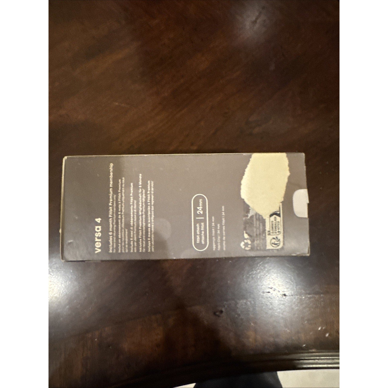 Packaging box of Fitbit Versa 4 Fitness Smartwatch in black showing product details on side panel