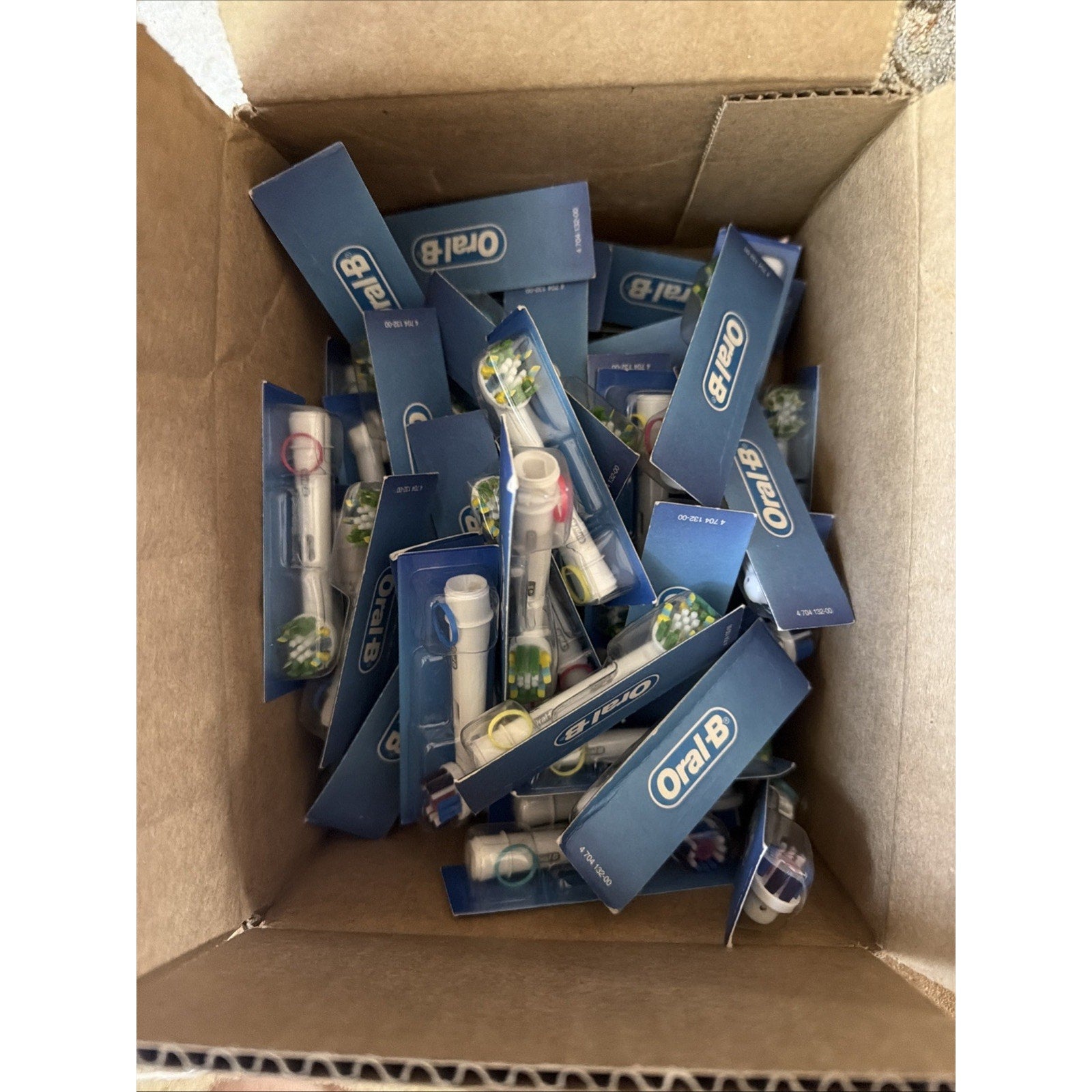 Box of 52 new Oral-B replacement toothbrush heads model 470413200 in individual blue packaging