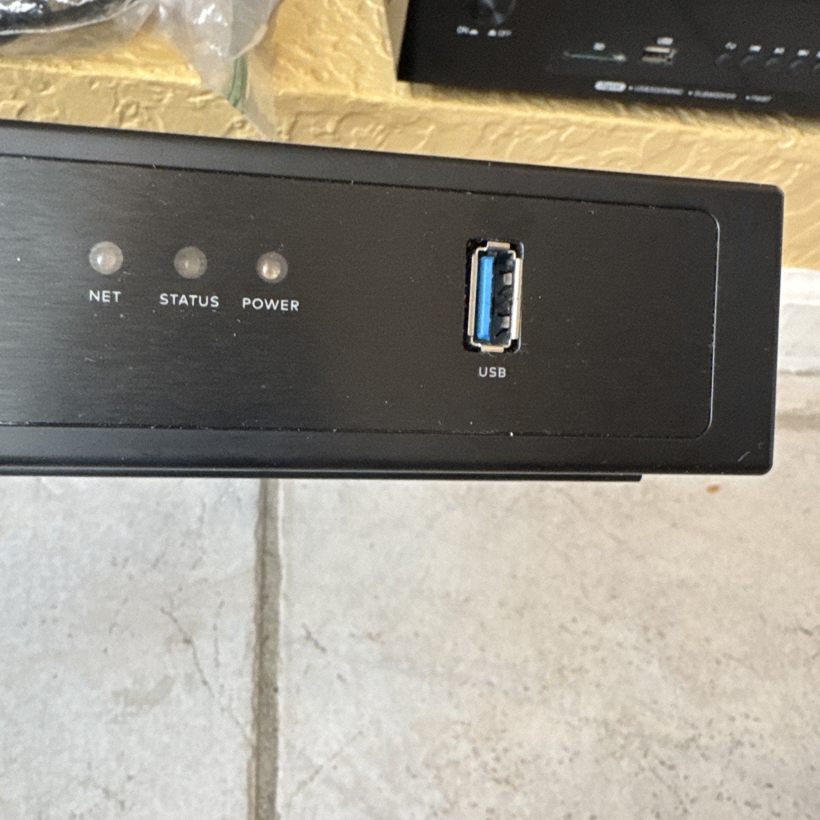 Close-up of Alarm.com 8CH Commercial Streaming Video Recorder front panel showing USB port and indicator lights for net, status, and power