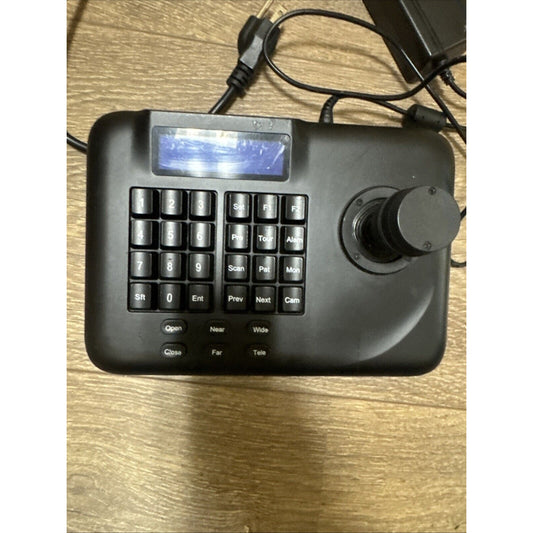 Wirepath Surveillance PTZ 3D Controller WPS-ACC-PTZ-CTRL with joystick and keypad on wooden surface with cables attached