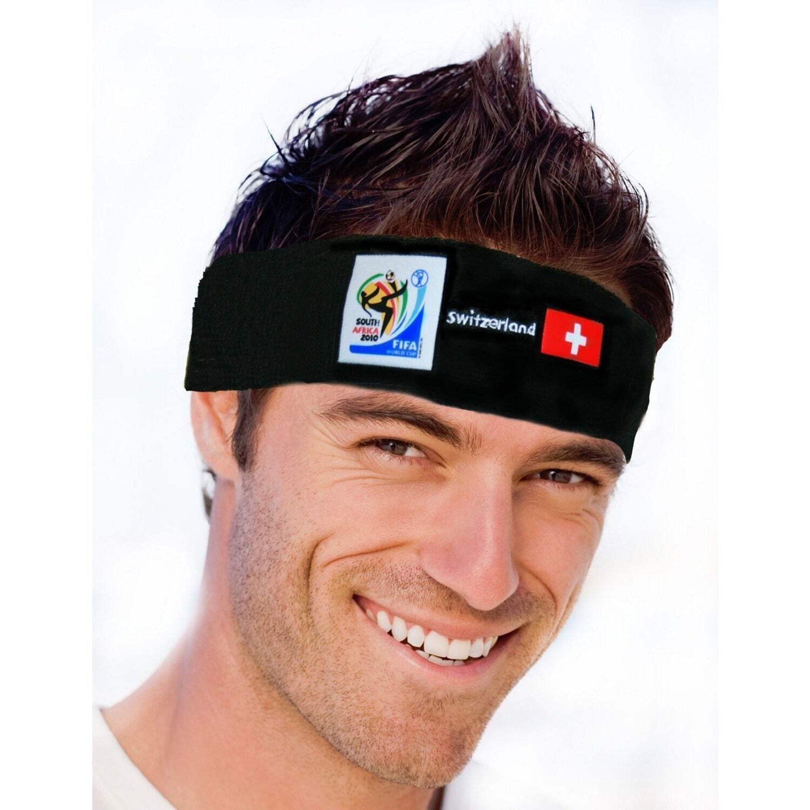 Man smiling and wearing a black headband featuring the 2010 FIFA World Cup logo, the Switzerland flag, and "Switzerland" text against a white background.
