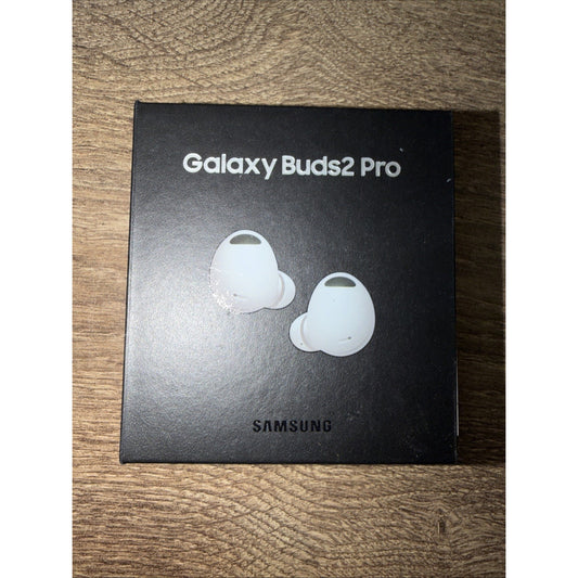 Black Samsung Galaxy Buds2 Pro box with silver text and an image of two white wireless earbuds, set on a wooden surface.