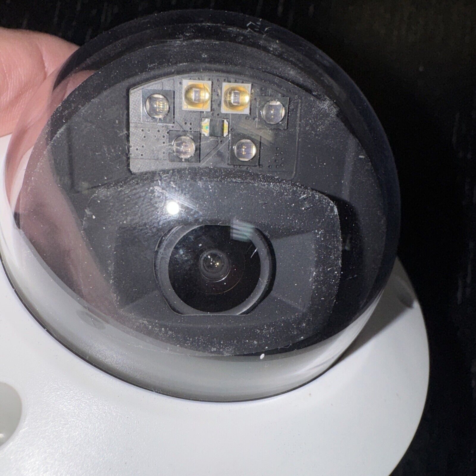 Close-up of Alarm.com ADC-VC826 POE dome security camera with visible lens and infrared LEDs inside clear protective cover