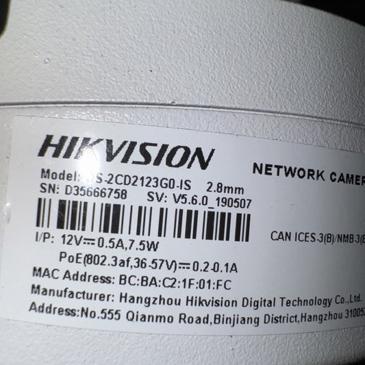 Close-up photo of Hikvision DS-2CD2123G0-IS dome camera label showing model, serial number, and technical details