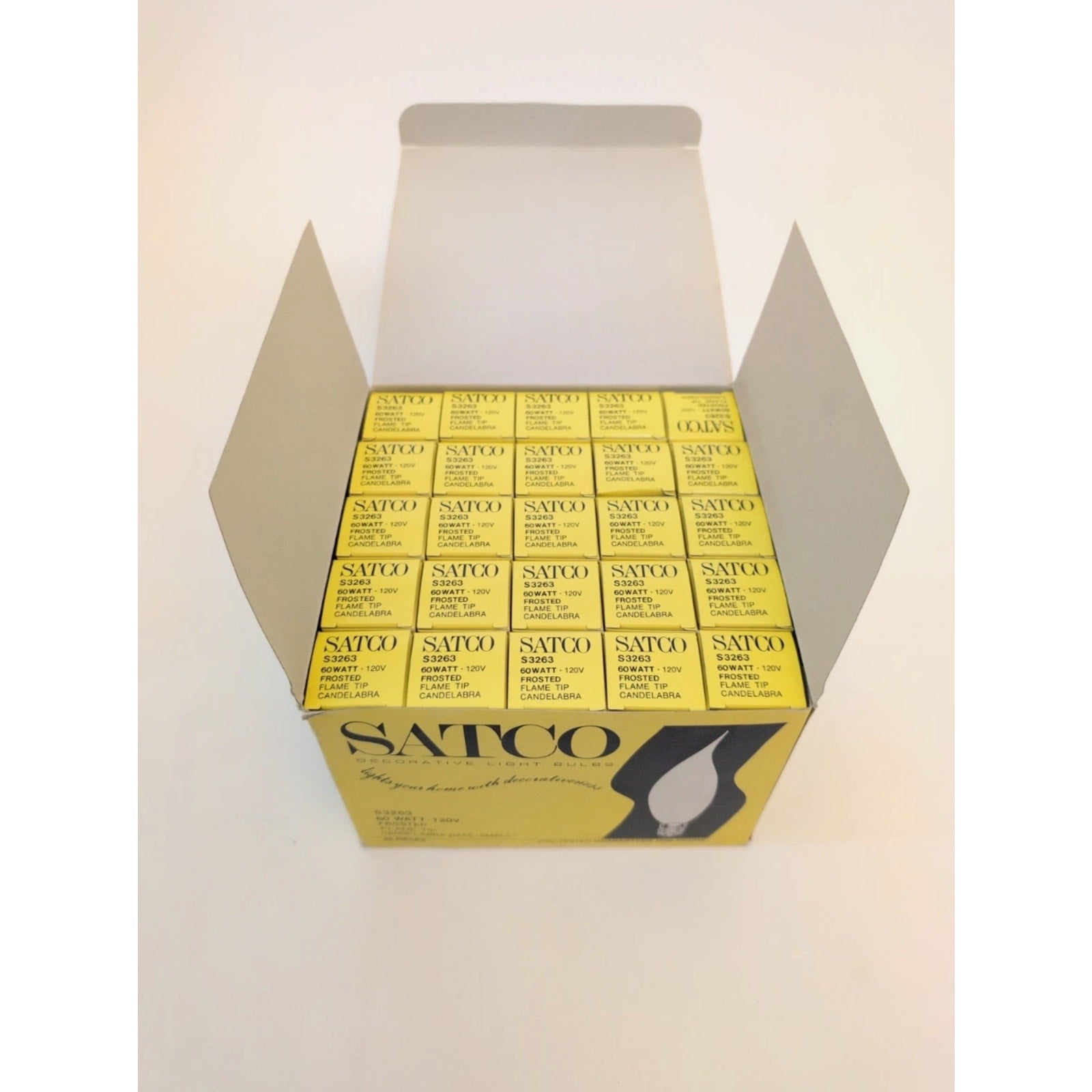 Open yellow box filled with multiple smaller yellow boxes labeled Satco, showing product numbers and details against a white background.