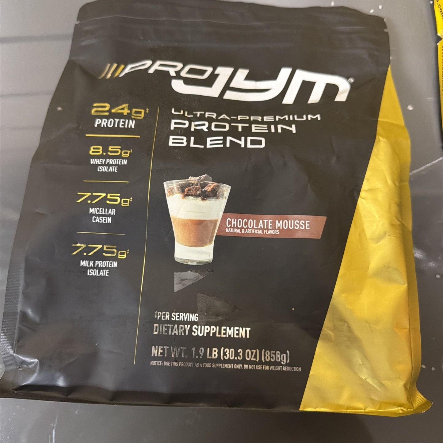 Black and yellow resealable pouch of Pro Jym ultra-premium protein blend dietary supplement in chocolate mousse flavor, displaying nutritional content per serving on front.