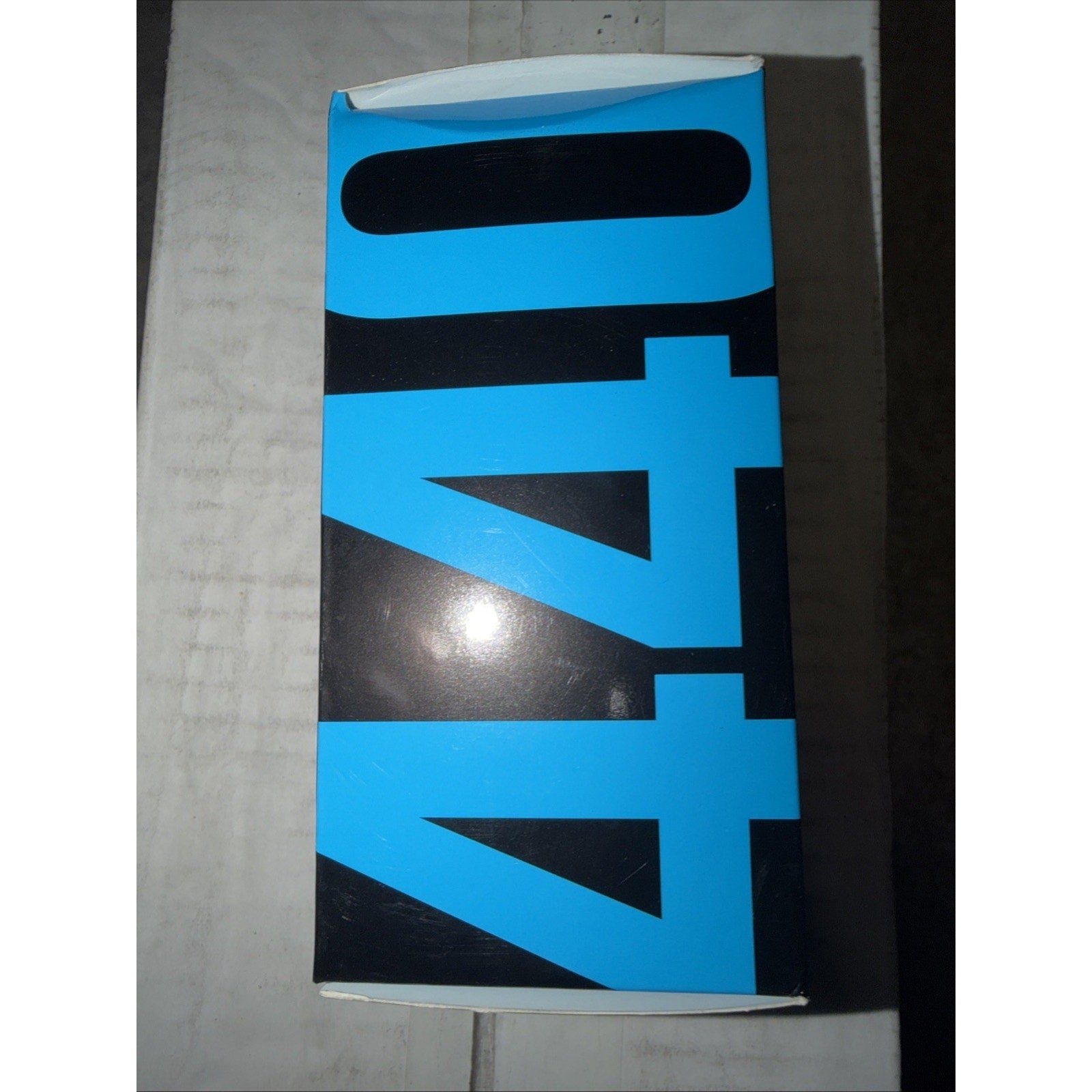 Rectangular cardboard box with bold blue and black graphic design featuring large numbers "440" prominently displayed on the front.