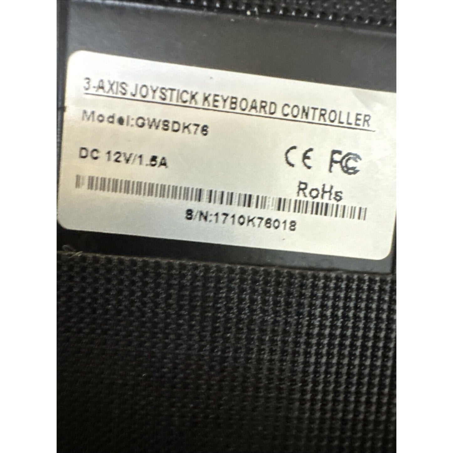 3-axis joystick keyboard controller model GWSDK76 label showing power and certification details on black textured surface