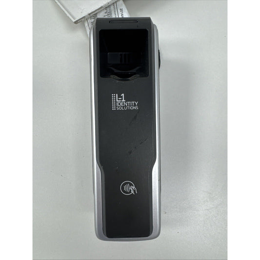 Portable black and silver electronic device with a fingerprint scanner and contactless payment symbol, branded with "L1 Identity Solutions" on a white surface.