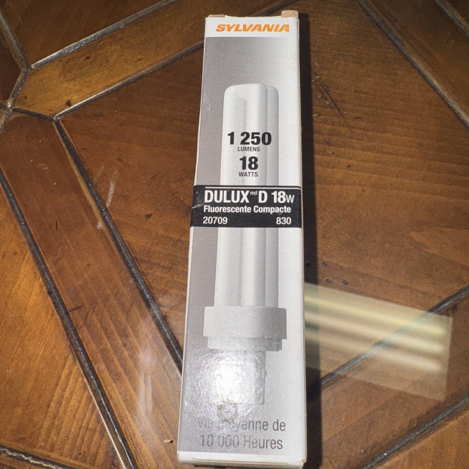 Sylvania 18 watt compact fluorescent light bulb box showing 1250 lumens and model 20709 with eco-friendly label