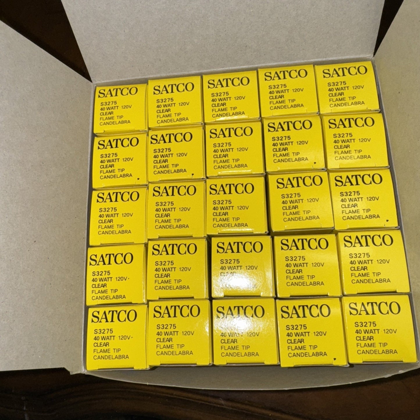 Case of 25 SATCO S3275 40 watt 120V clear flame tip candelabra light bulbs in yellow packaging