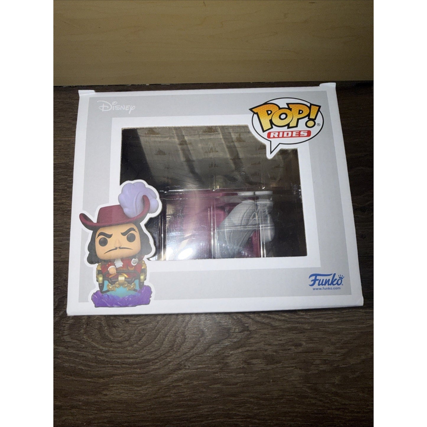 Funko Pop! Rides collectible figure featuring Captain Hook from Disney, displayed inside a white box with a clear window and colorful character artwork on the front.