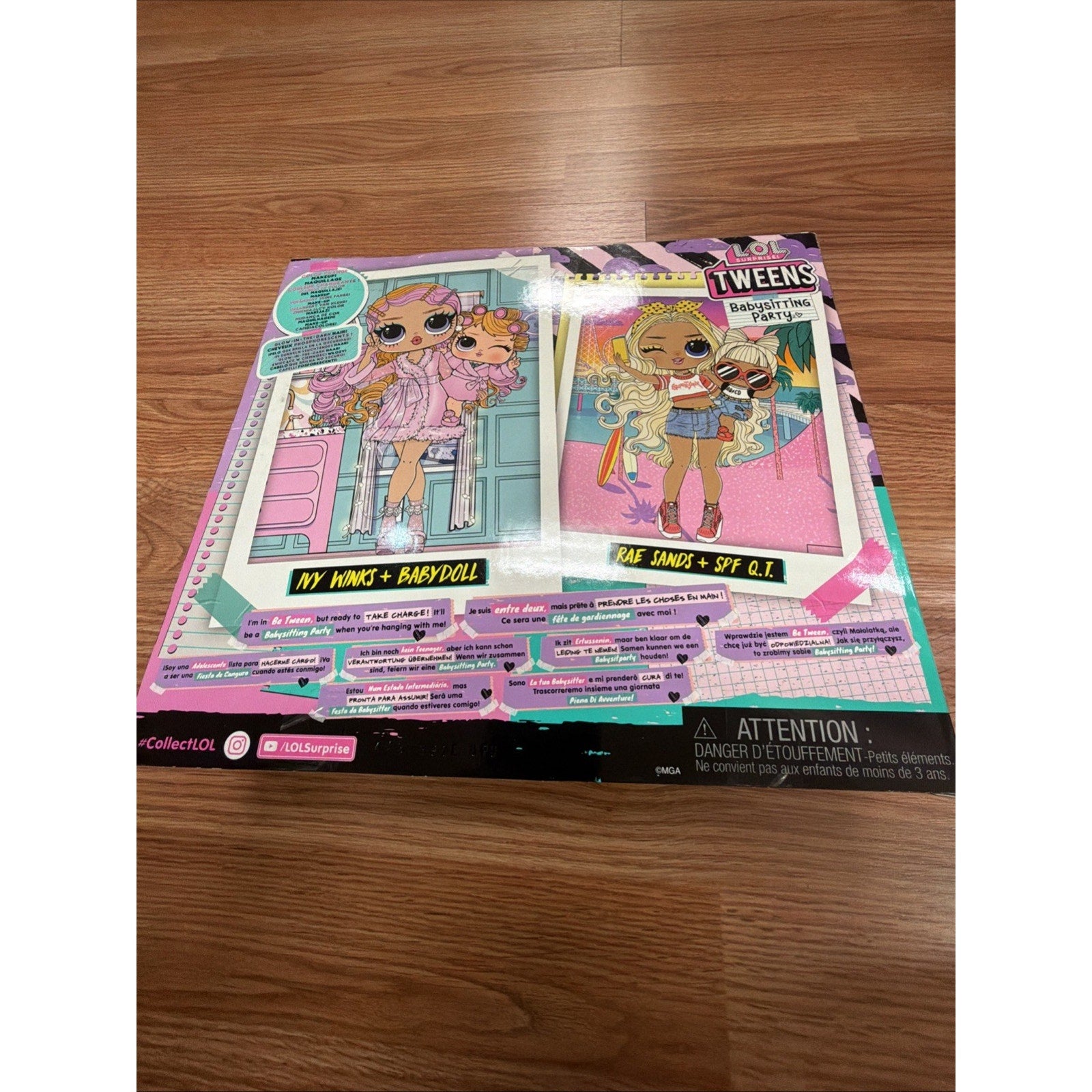 Flat lay of a colorful cardboard display featuring LOL Surprise Tweens dolls with vibrant clothing and accessories, placed on a wooden floor surface.