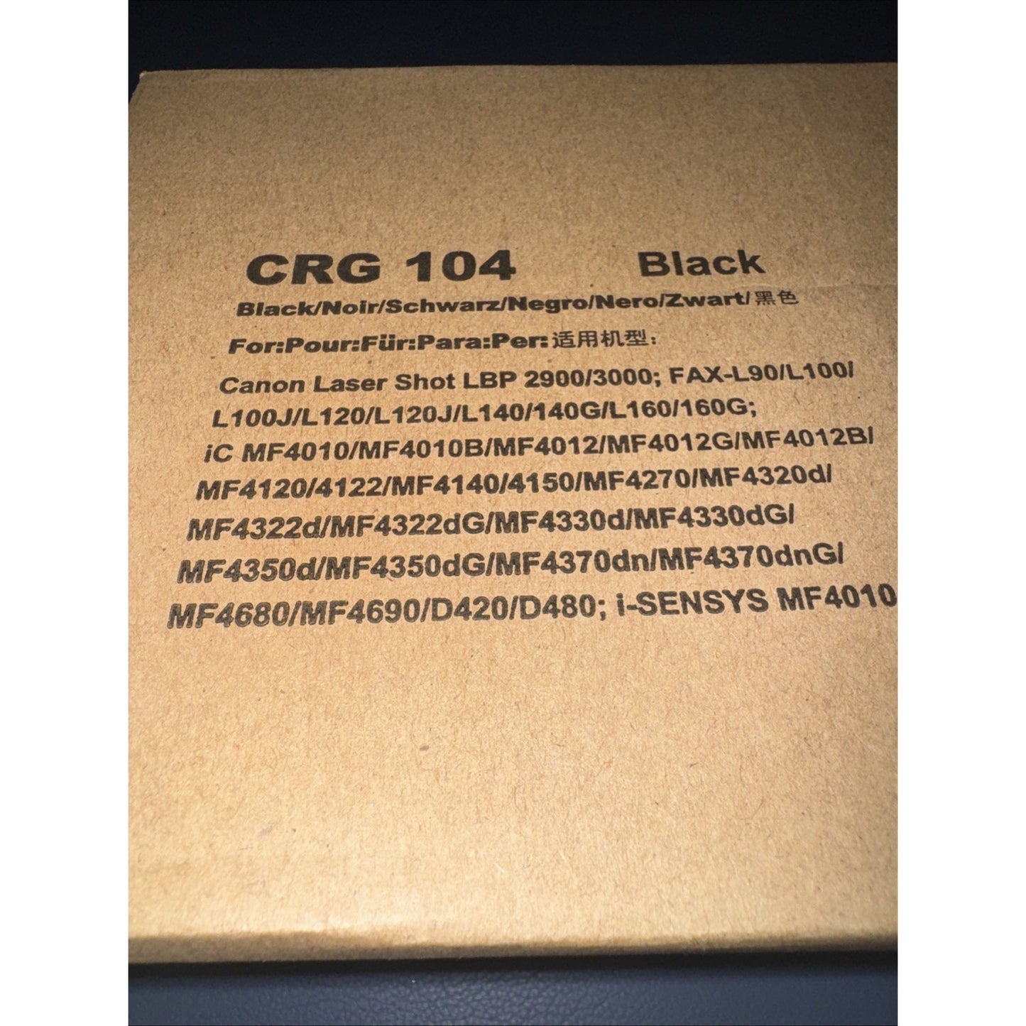 Brown cardboard box label showing black toner cartridge model CRG 104 compatibility with various Canon Laser Shot, iC, and i-SENSYS printer and fax machine models.