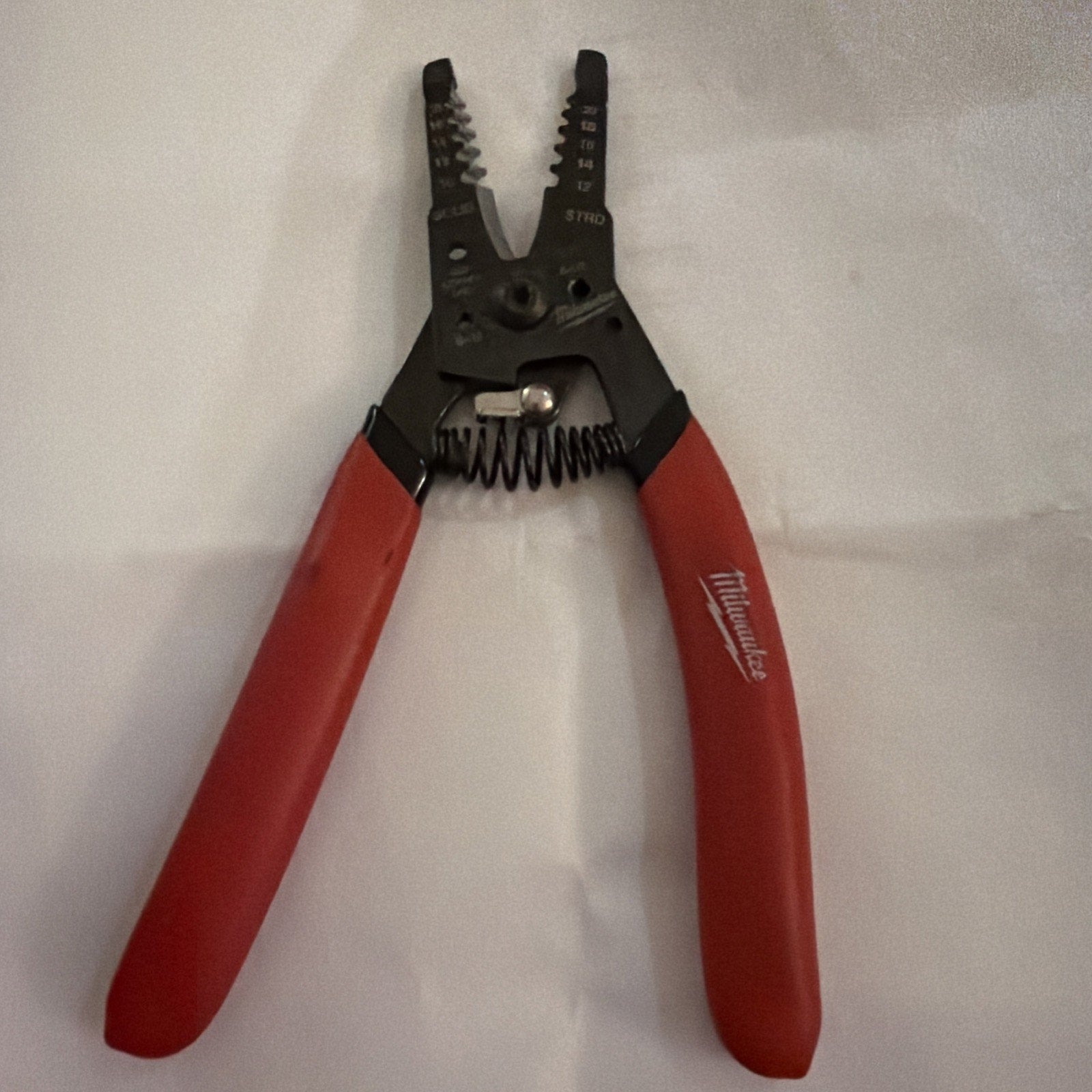 Milwaukee Automatic Wire Stripper with red handles for stripping 10 to 20 AWG wire sizes showing tool details