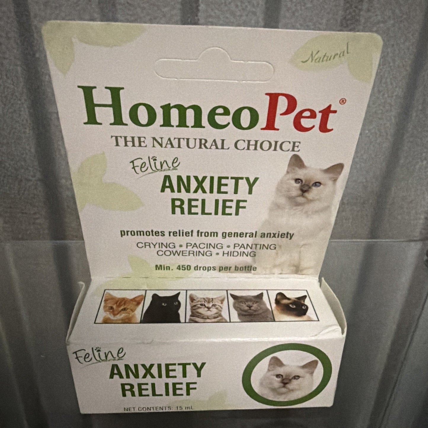 Packaging of HomeoPet natural feline anxiety relief remedy featuring a white cat image, with text highlighting benefits for anxiety symptoms like crying and panting.