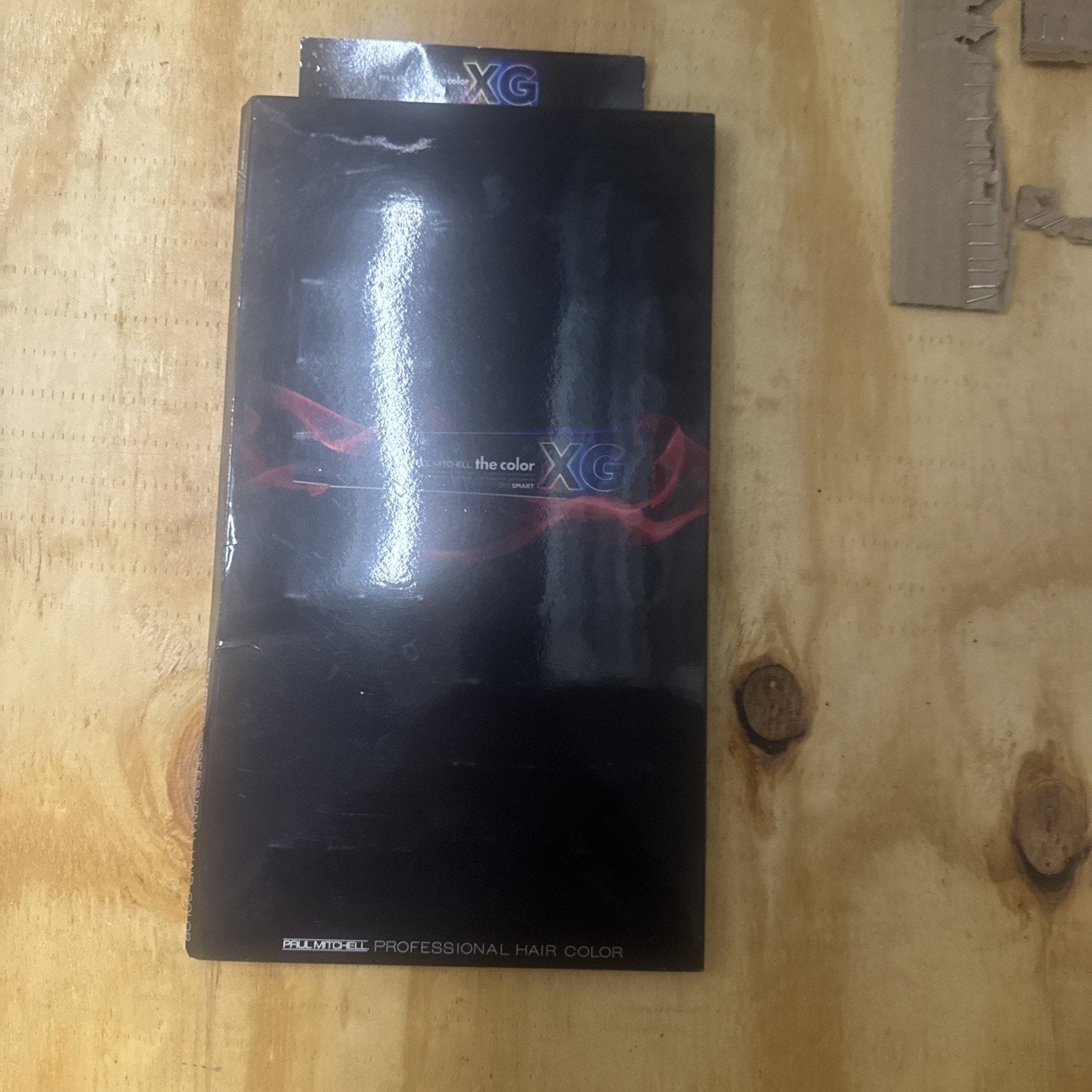 Paul Mitchell The Color XG professional hair color swatch book displaying range of hair coloring samples