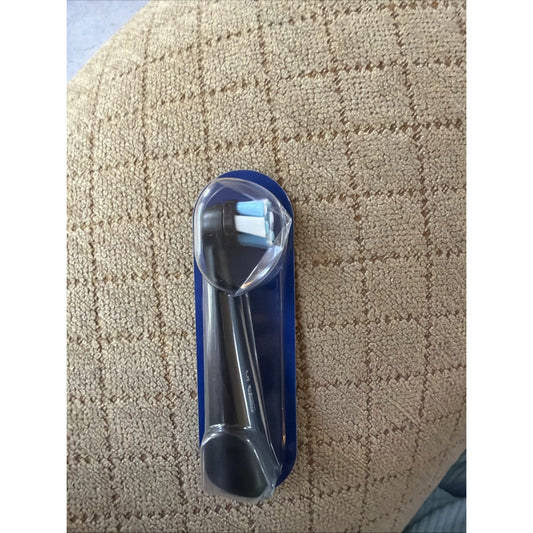 19 Count Oral-B iO Series Ultimate Clean Replacement Brush Head in black with bristles packaged on textured fabric surface