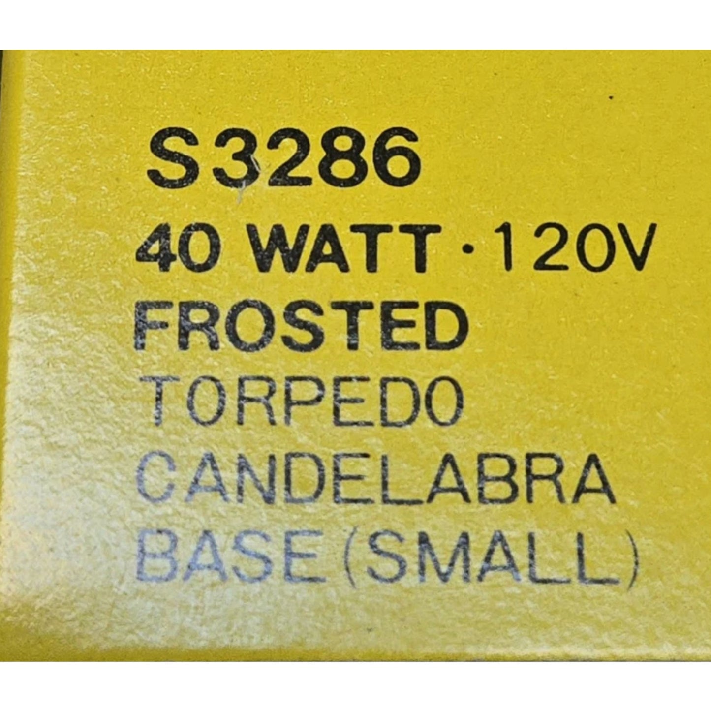 Close-up of yellow label showing SATCO S3286 40 watt 120V frosted torpedo candelabra small base bulb specifications