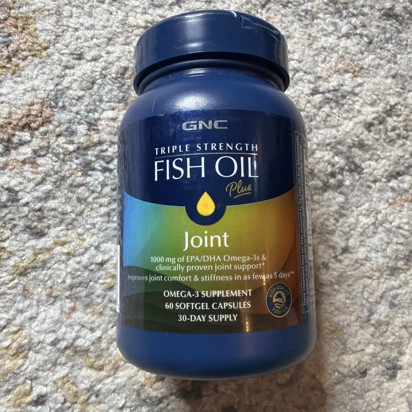 Blue plastic bottle labeled GNC Triple Strength Fish Oil Plus Joint supplement, featuring 1000 mg of EPA/DHA Omega-3s, claiming to improve joint comfort and stiffness, containing 60 softgel capsules for a 30-day supply.
