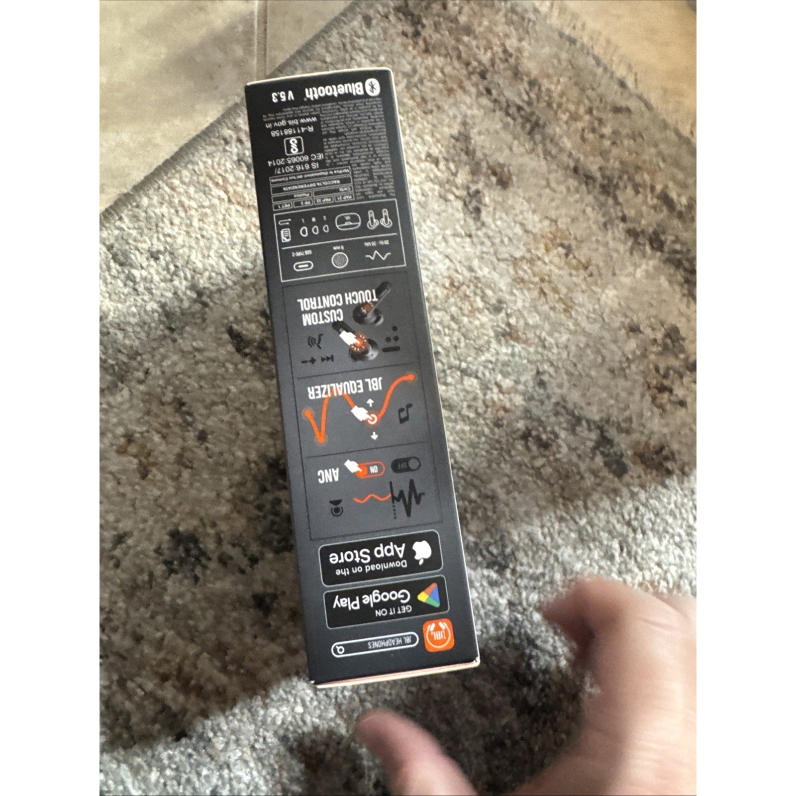 Box side view of JBL Tune Beam wireless earbuds packaging showing Bluetooth, app compatibility, and control icons in black design