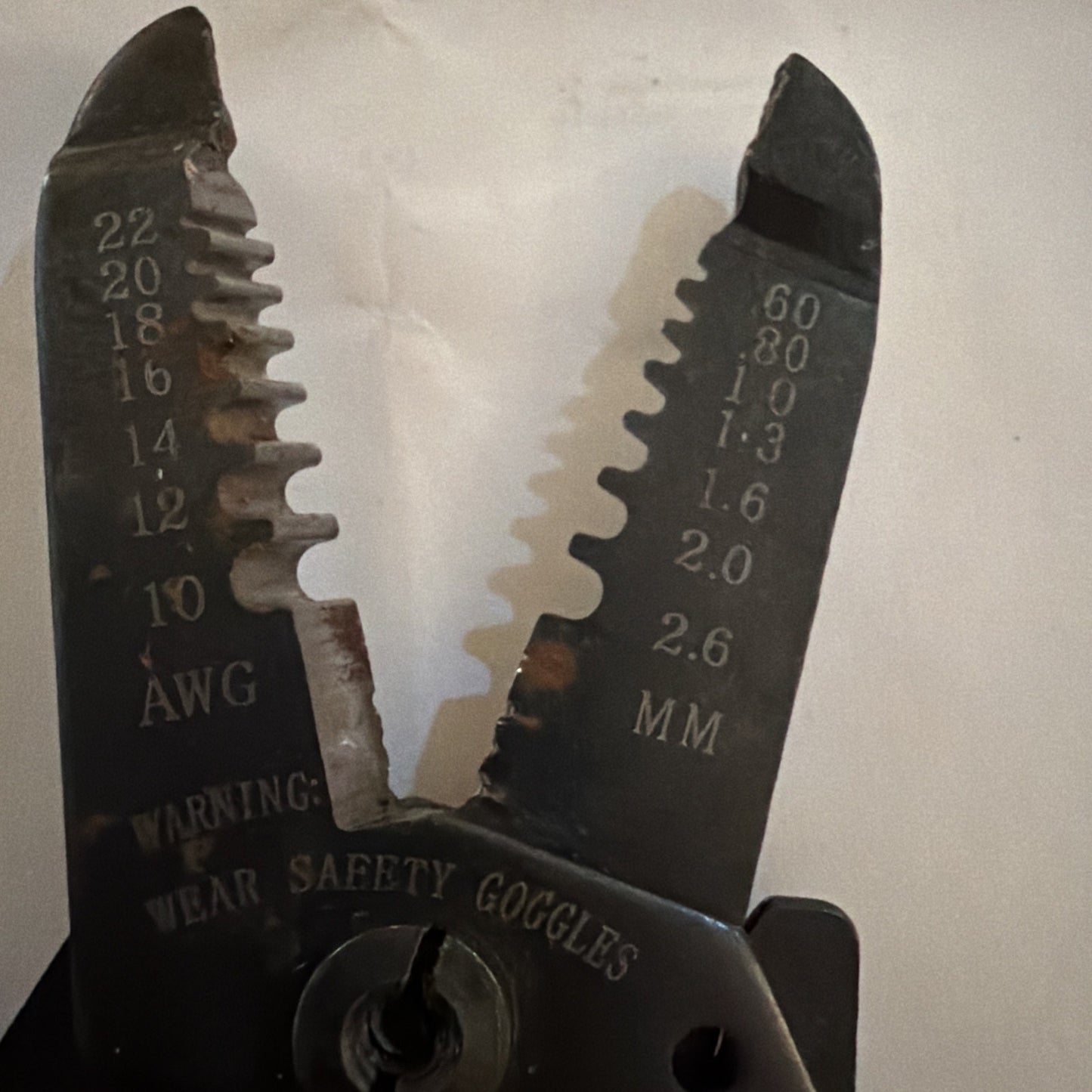 Jonard JIC-1022 wire stripper cutter showing AWG and metric wire size notches with safety warning text visible