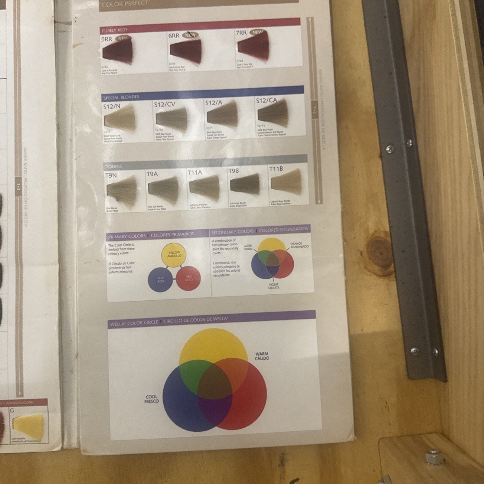 Wella Color Perfect Color Guide showing hair color swatches and color theory charts on laminated pages