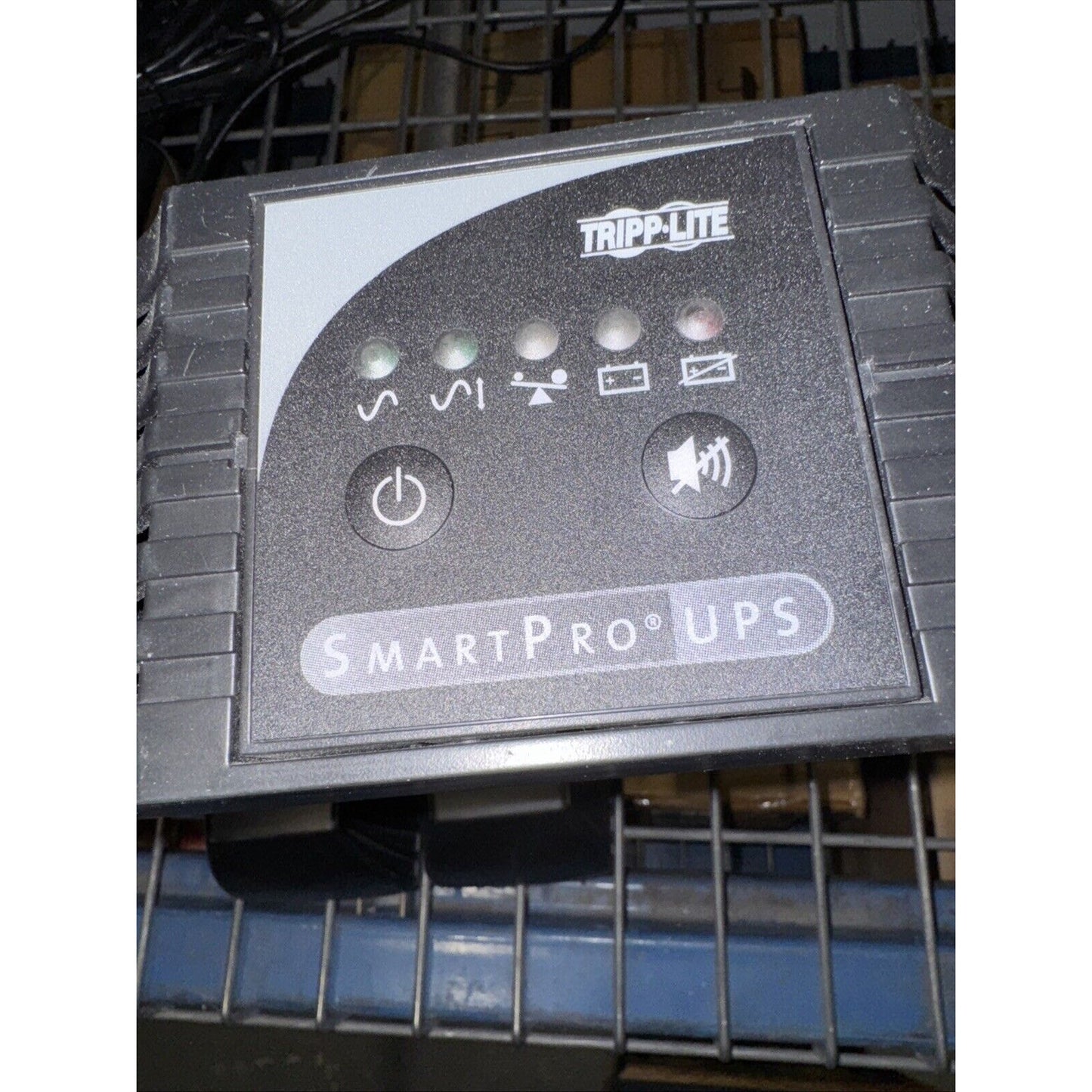 Tripp Lite SmartPro UPS control panel with power and mute buttons and indicator lights on black casing