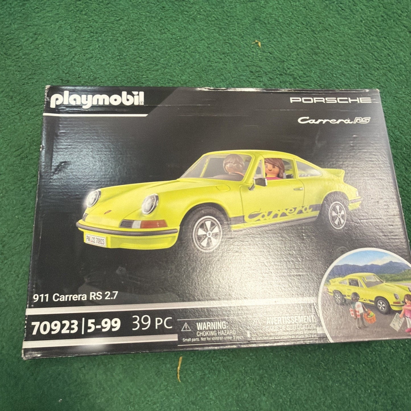 Playmobil toy set box featuring a yellow Porsche 911 Carrera RS 2.7 model car with two seated figures inside, designed for children aged 5 to 99, with 39 pieces included.