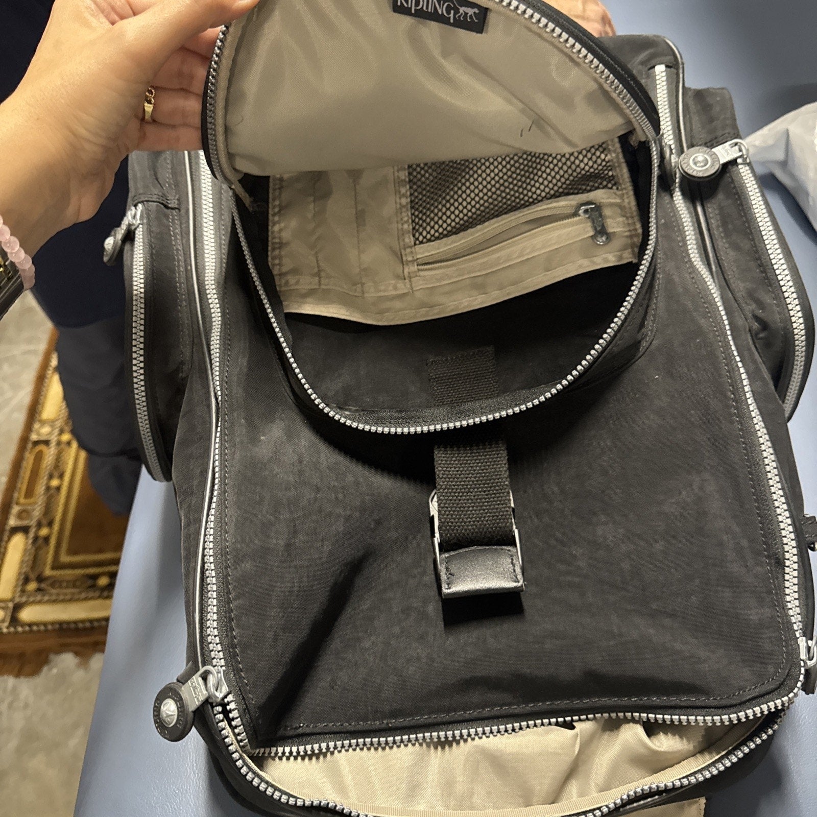 Kipling Gaze large rolling backpack open showing spacious main compartment with beige lining and zippered mesh pocket
