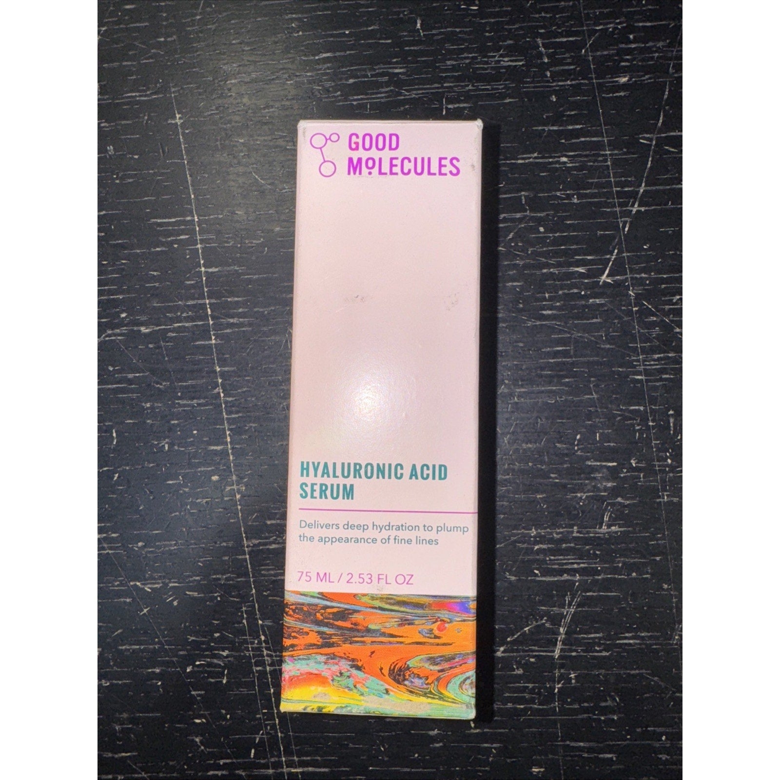 Good Molecules Hyaluronic Acid Serum box showing hydration benefits and colorful abstract design on bottom