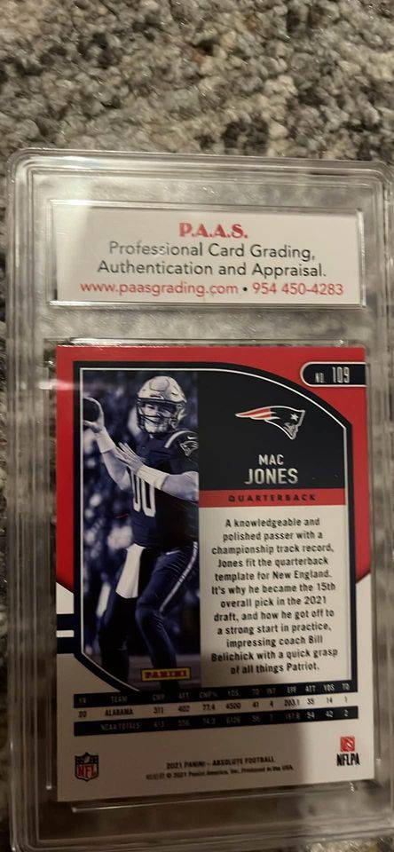 Mac Jones autographed trading card in protective graded case with certificate of authenticity visible
