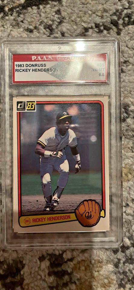 1983 Donruss Rickey Henderson baseball card graded 8.5 in protective case showing player in athletics uniform