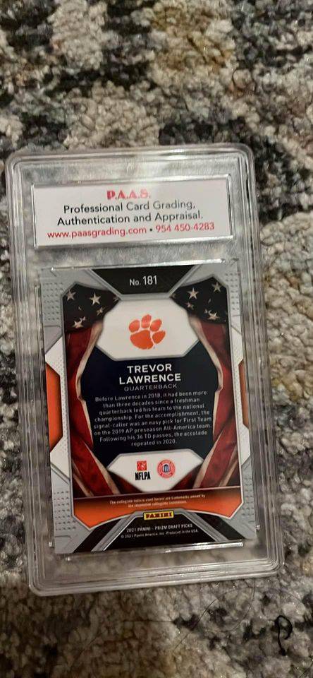 Trevor Lawrence football card graded by P.A.A.S. with authentication and appraisal, encased in protective plastic sleeve.